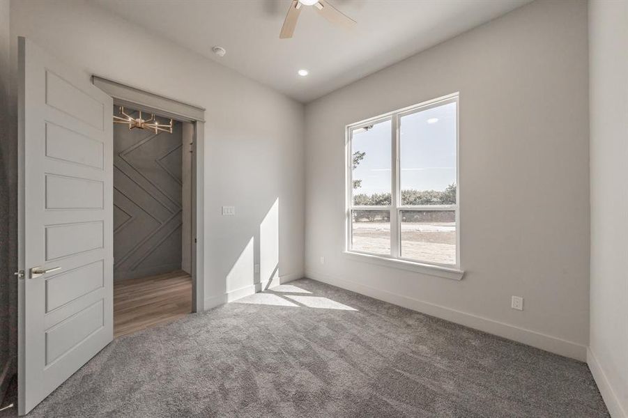 Unfurnished bedroom with carpet floors and a ceiling fan