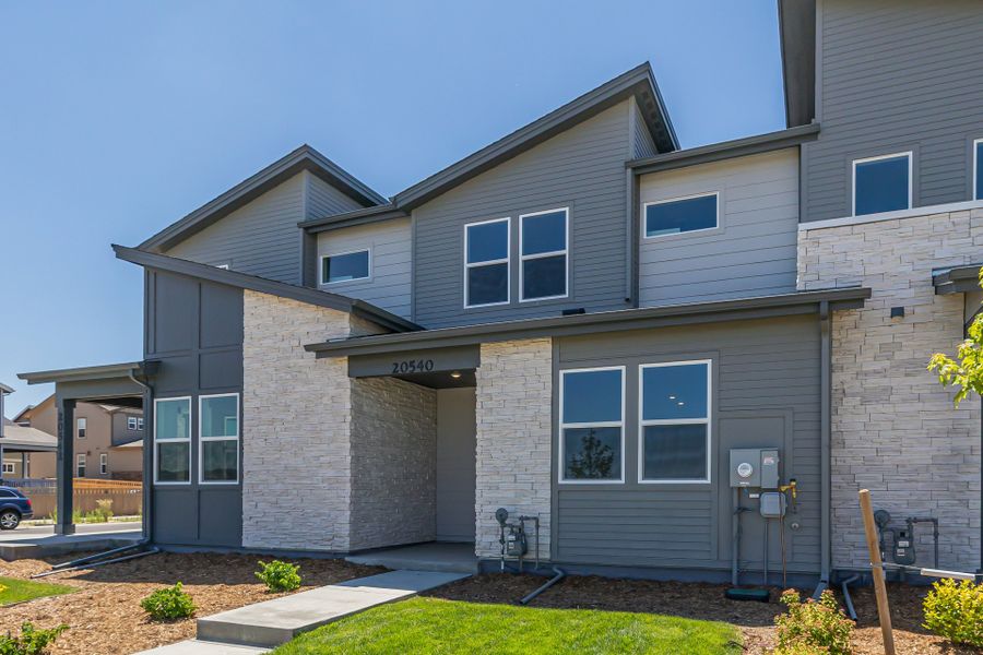 Front exterior of a new home in Painted Prairie, Aurora, CO, highlighting curb appeal (Image 2).