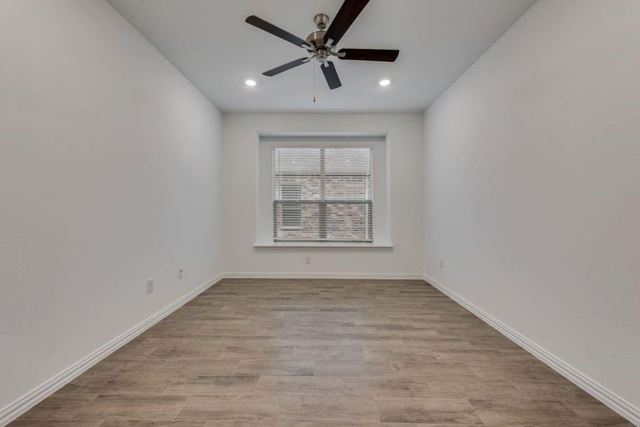 Empty room featuring ceiling fan and light hardwood / wood-style flooring