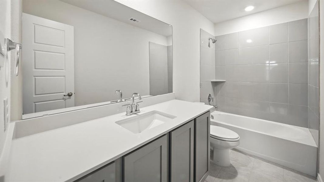 Bathroom featuring vanity, shower / bathtub combination, and light tile patterned flooring Bathroom featuring vanity, shower / bathtub combination, and light tile patterned flooring