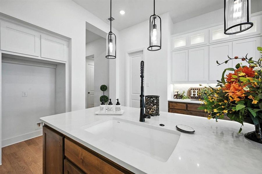 Bathroom with vanity, dark wood finished floors, and recessed lighting