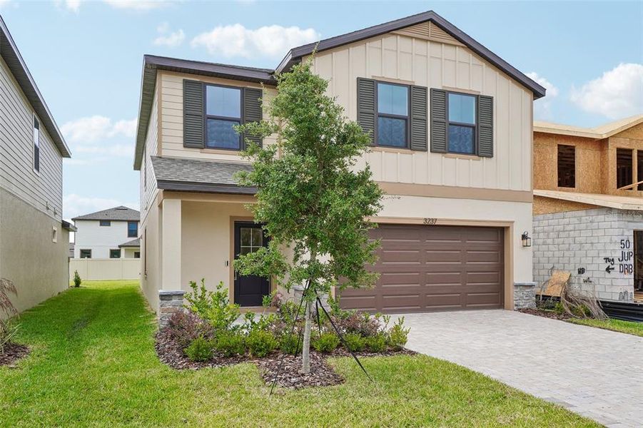 Front exterior of a new home in Grasslands West, Lakeland, FL, highlighting curb appeal (Image 20).