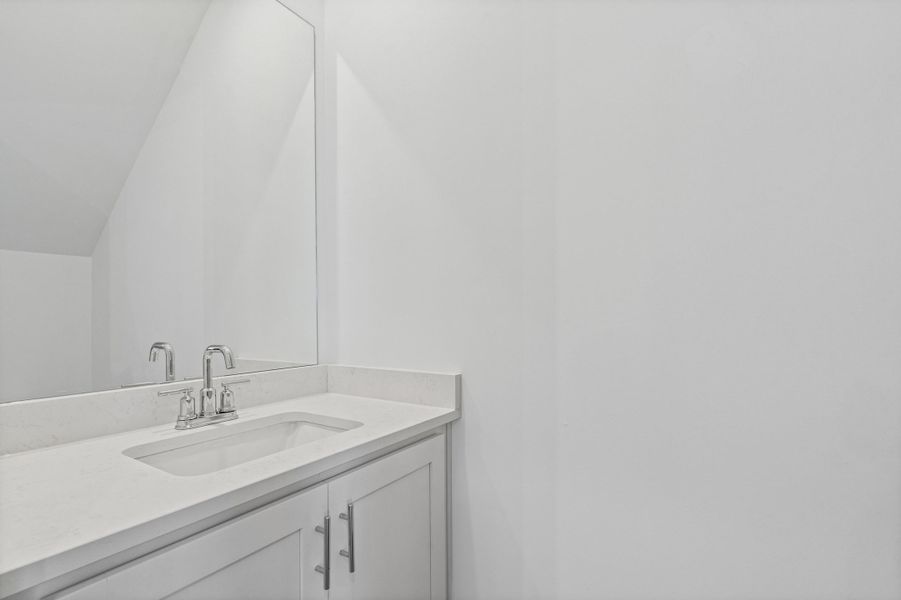 Integrated vanity with light-toned countertop and an undermount sink