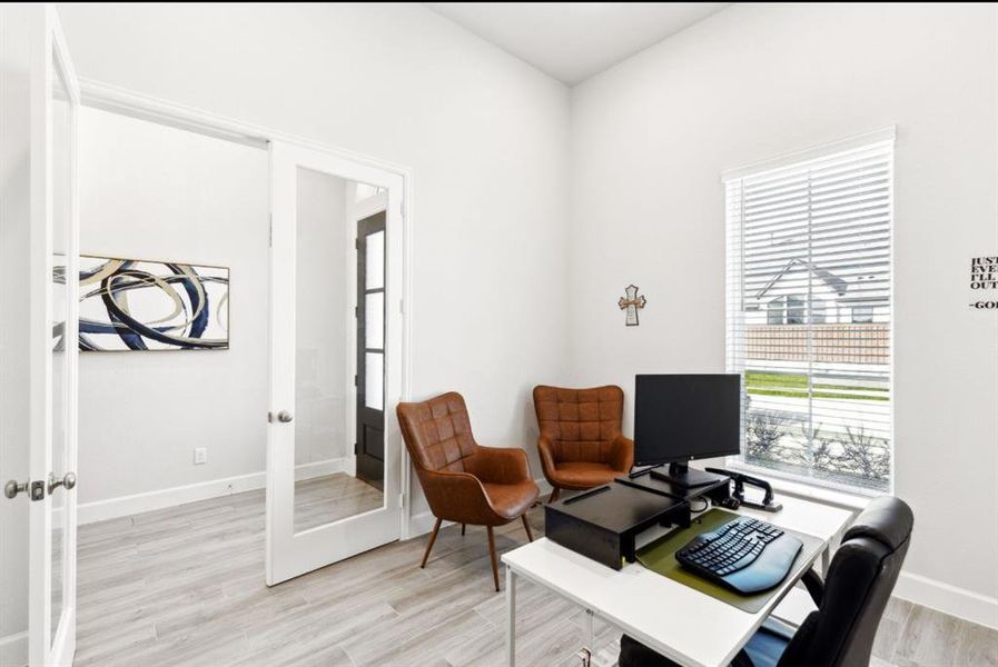Office area with french doors and light wood-type flooring