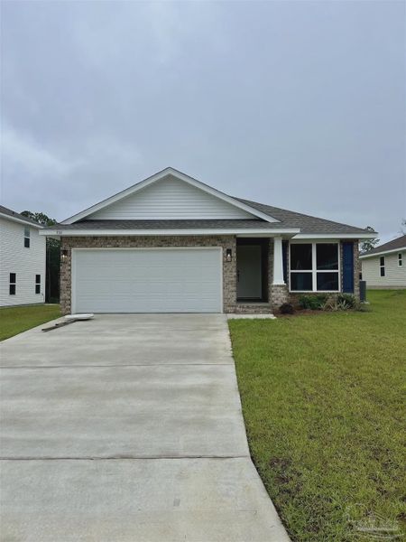 Front exterior of a new home in Pine Top, Cantonment, FL, highlighting curb appeal (Image 1).