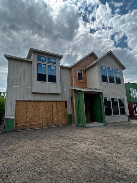 Modern architectural design with vertical siding and wood-finish accents Modern architectural design with vertical siding and wood-finish accents