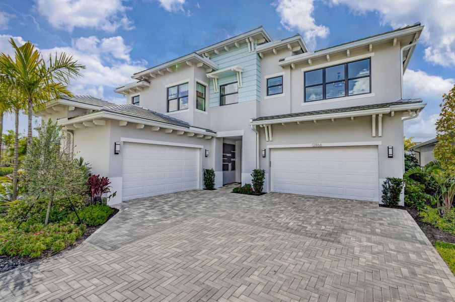 Front exterior of a new home in Apex at Avenir, Palm Beach Gardens, FL, highlighting curb appeal (Image 2).