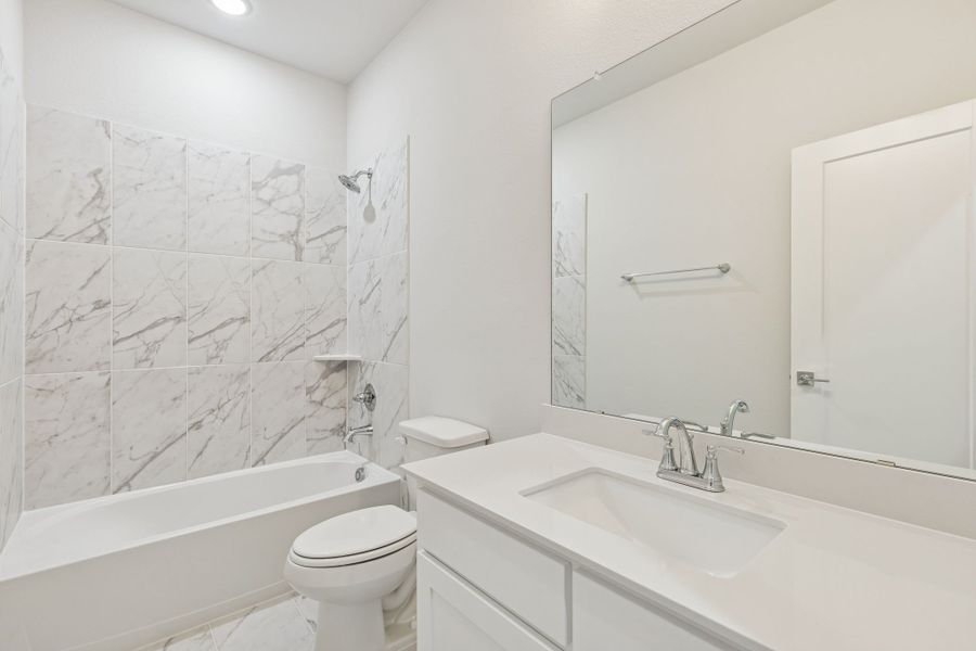 Bathroom in the Masters home plan by Trophy Signature Homes – REPRESENTATIVE PHOTO