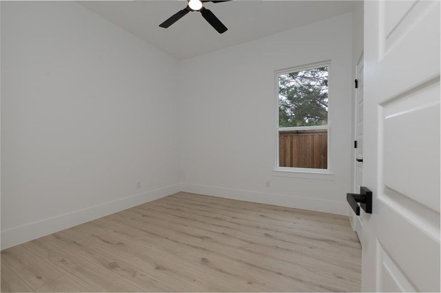 Unfurnished room with light wood-style flooring and a ceiling fan