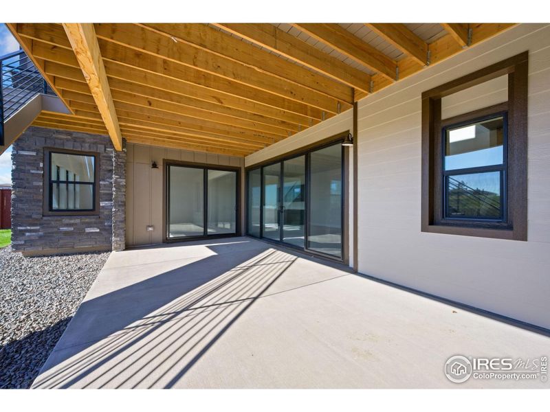 Exterior details and patio area of a home in The Fairways at RainDance, Windsor (Image 12).