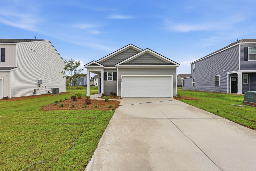 Front exterior of a new home in Pine Hills at Cane Bay, Summerville, SC, highlighting curb appeal (Image 2). Front exterior of a new home in Pine Hills at Cane Bay, Summerville, SC, highlighting curb appeal (Image 2).