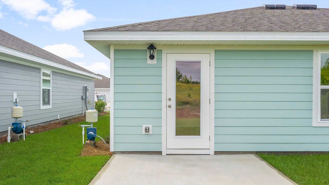 Front exterior of a new home in Magnolia at the Bluffs Phase 3, Freeport, FL, highlighting curb appeal (Image 2).