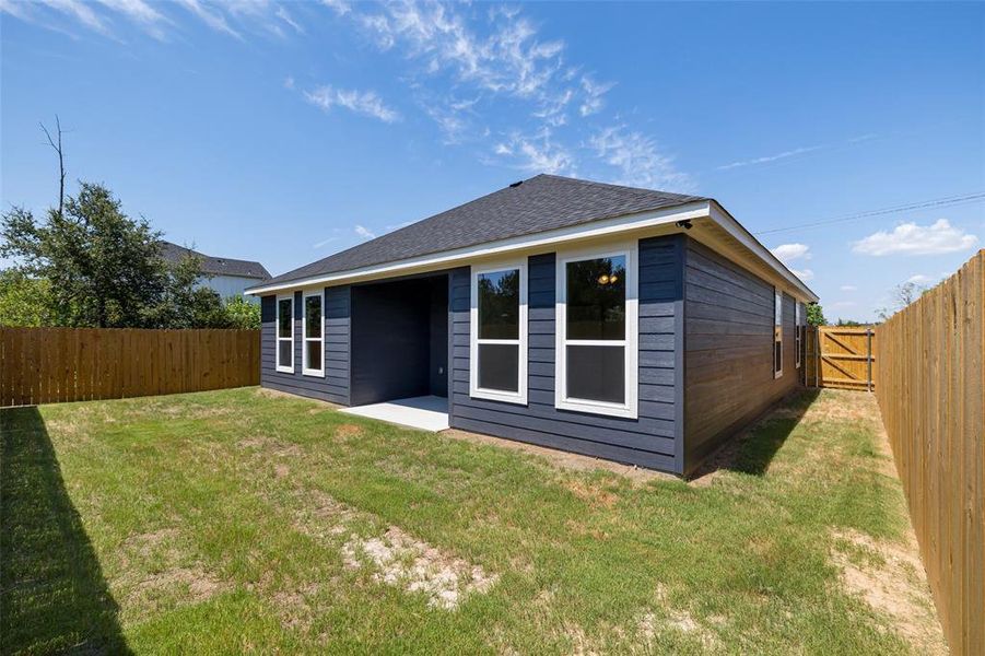 Rear view of house with a lawn