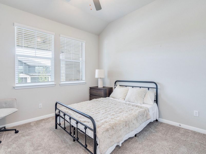 Third bedroom features double windows and carpeted flooring define this cozy bedroom.