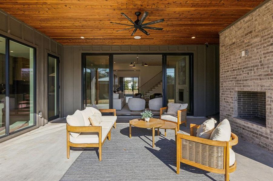 View of patio with an outdoor living space and ceiling fan