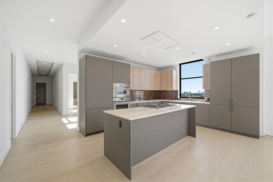 Kitchen featuring premium finishes and fixtures, this kitchen is designed for both aesthetics and utility Kitchen featuring premium finishes and fixtures, this kitchen is designed for both aesthetics and utility