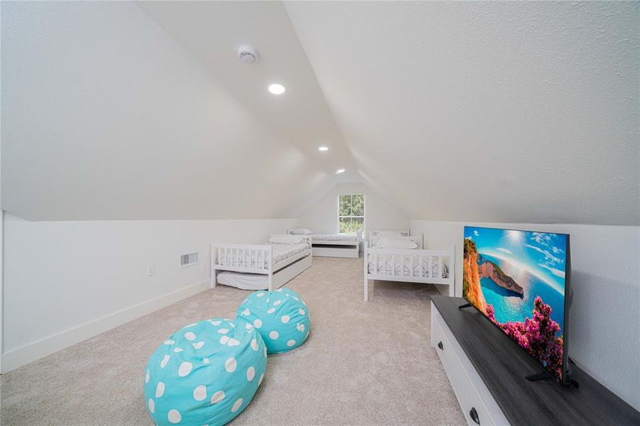 Carpeted bedroom featuring vaulted ceiling and recessed lighting Carpeted bedroom featuring vaulted ceiling and recessed lighting