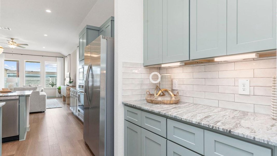 Entry into the kitchen from the dining area with extra shelving and counter for additional storage Entry into the kitchen from the dining area with extra shelving and counter for additional storage