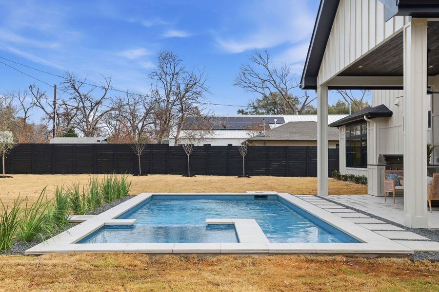 Relaxing pool / spa featuring a fenced backyard and a patio area