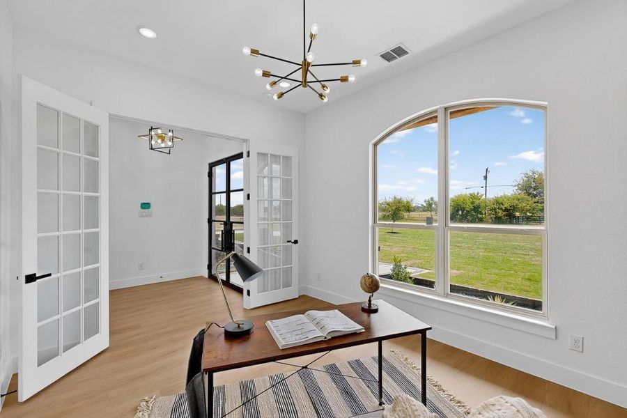 Office with a chandelier, french doors, light wood finished floors, and recessed lighting