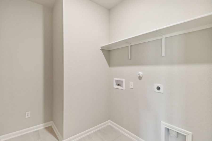 Laundry room in the Callaghan floorplan at a Meritage Homes community.