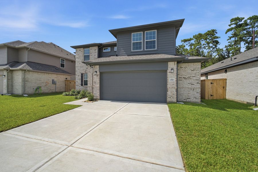 Front exterior of a new home in Sundance Cove, Crosby, TX, highlighting curb appeal (Image 2).