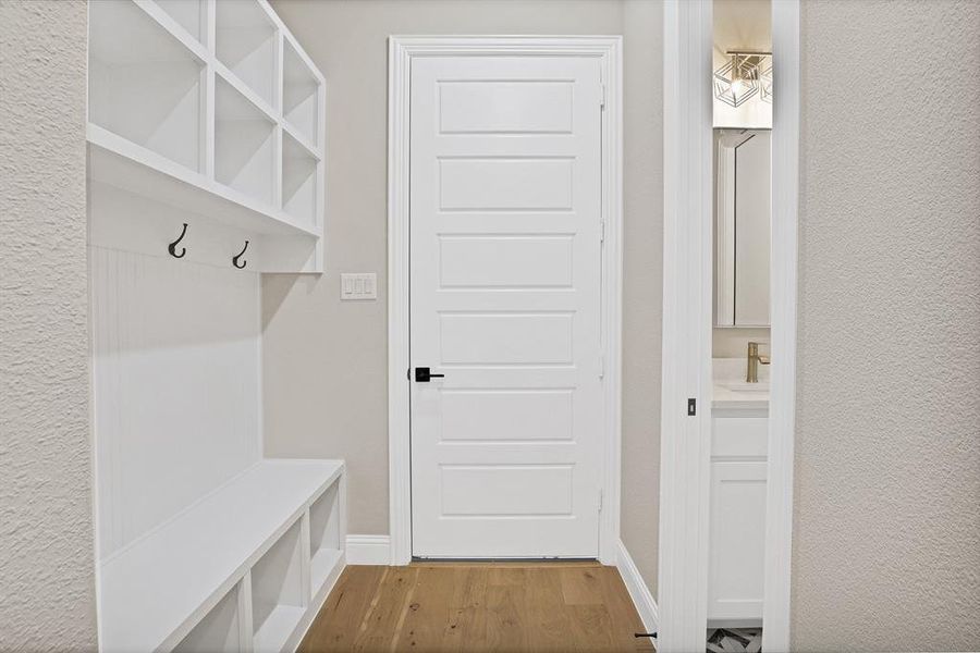 Mudroom with sink and light hardwood / wood-style floors