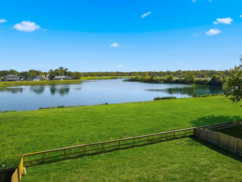 Breathtaking lake views create the perfect backdrop for this home! Relax and unwind as you watch the sunlight shimmer across the clean, peaceful water just beyond your backyard.