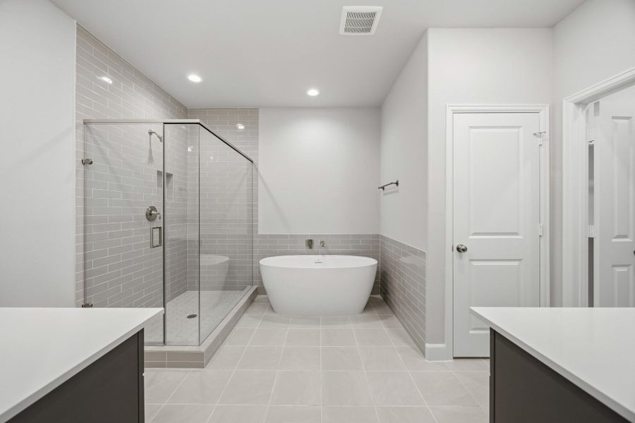 Soak away the stress of the day in your freestanding tub while your favorite playlist echoes off spa-white walls. This luxury en suite was made for unwinding. Soak away the stress of the day in your freestanding tub while your favorite playlist echoes off spa-white walls. This luxury en suite was made for unwinding.