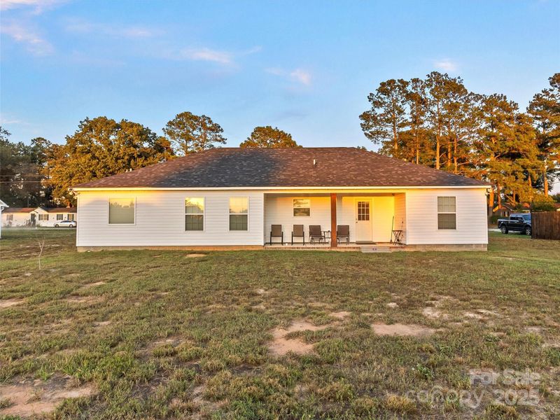 Back View / Back Porch Complete with Patio Furniture (that conveys with the sale)