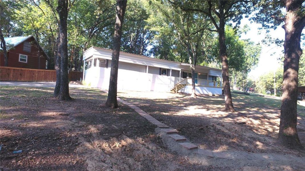 Front exterior of a new home in , Malakoff, TX, highlighting curb appeal (Image 1).
