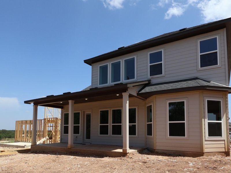 A new construction home with an inviting covered patio awaits its finishing touches.