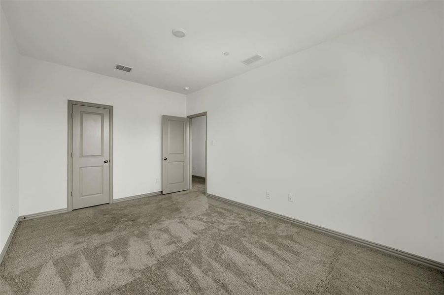 Unfurnished bedroom featuring carpet flooring and baseboards Unfurnished bedroom featuring carpet flooring and baseboards