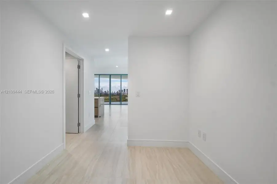 Interior space featuring large-format tile flooring, recessed lighting, and expansive floor-to-ceiling windows