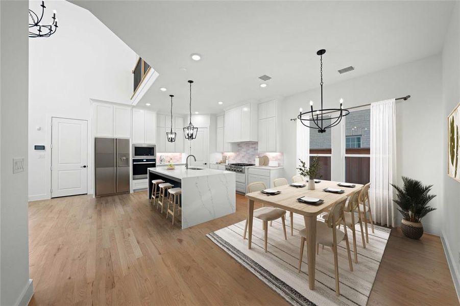 Kitchen with a chandelier, stainless steel appliances, white cabinets, light wood-style flooring, and recessed lighting Kitchen with a chandelier, stainless steel appliances, white cabinets, light wood-style flooring, and recessed lighting