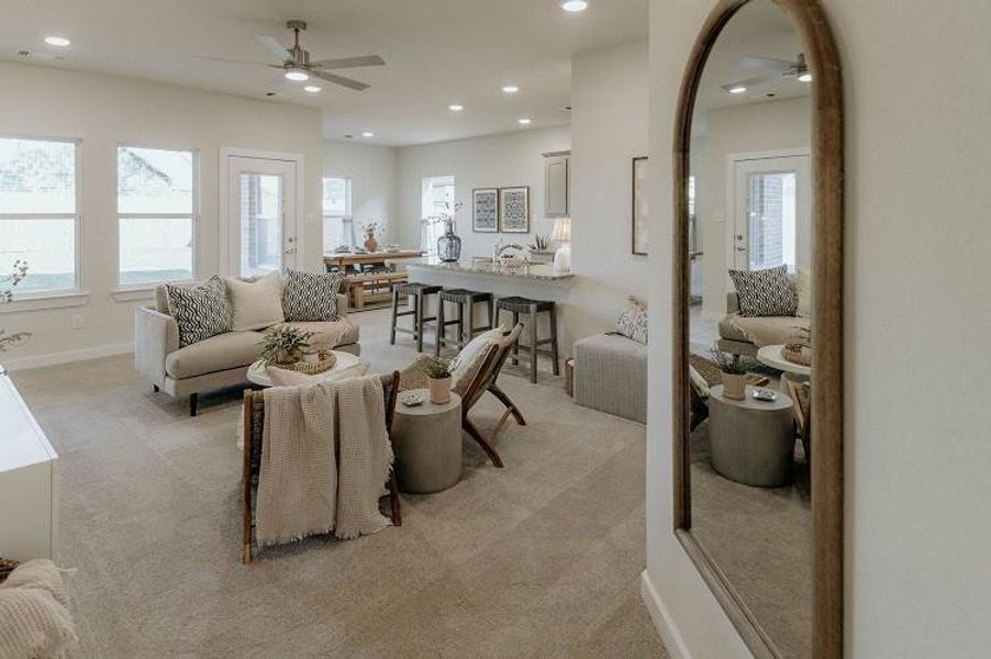 Living room featuring ceiling fan, light carpet, recessed lighting, healthy amount of natural light, and arched walkways Living room featuring ceiling fan, light carpet, recessed lighting, healthy amount of natural light, and arched walkways