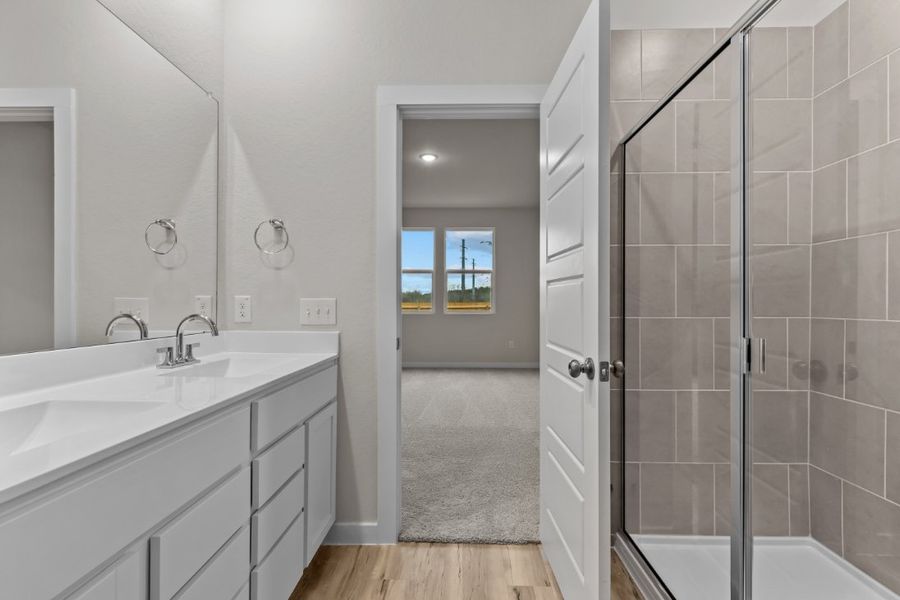 A bathroom with a glass shower. A bathroom with a glass shower.
