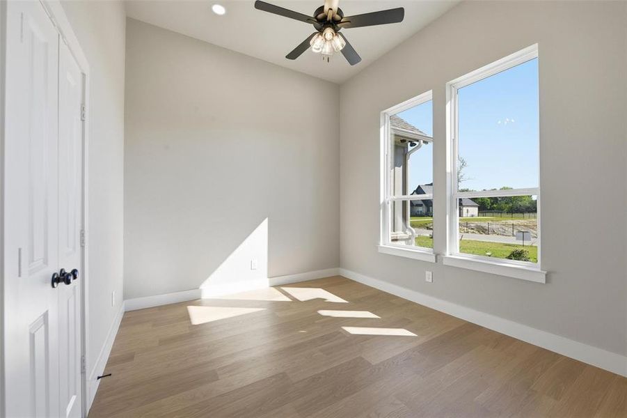 Unfurnished room featuring light wood-style floors, ceiling fan, and recessed lighting