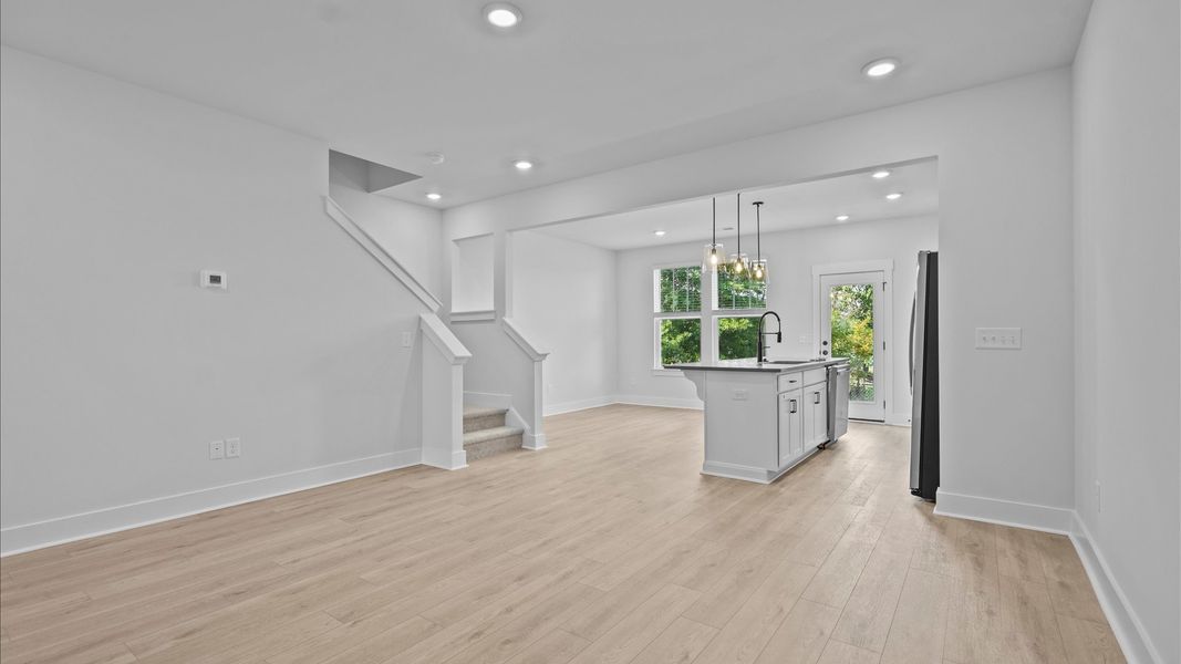 Elegant family room with hardwood flooring and open-concept flow in this first-class DRB Homes design Elegant family room with hardwood flooring and open-concept flow in this first-class DRB Homes design