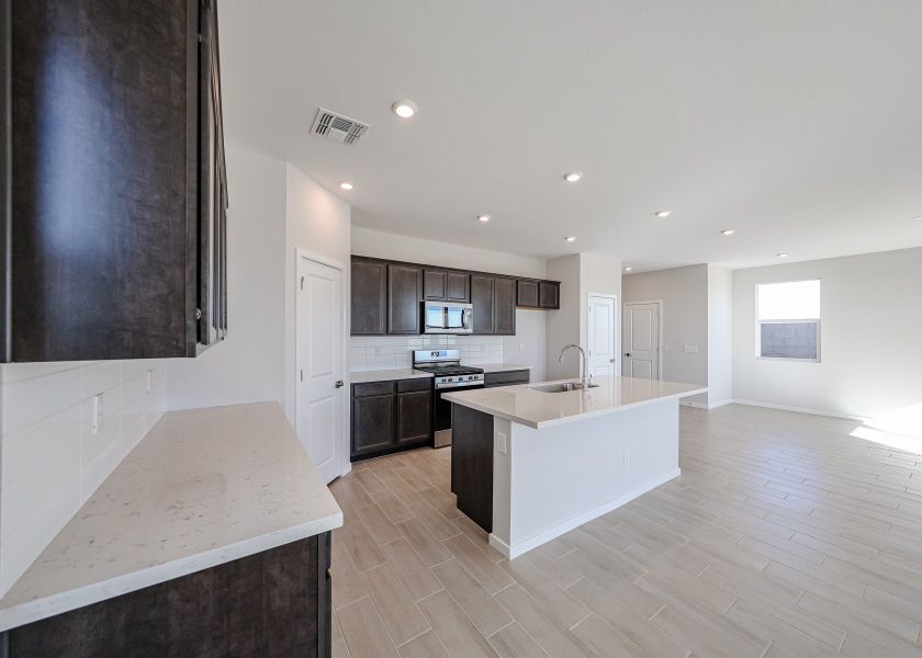 A kitchen with black cabinets.