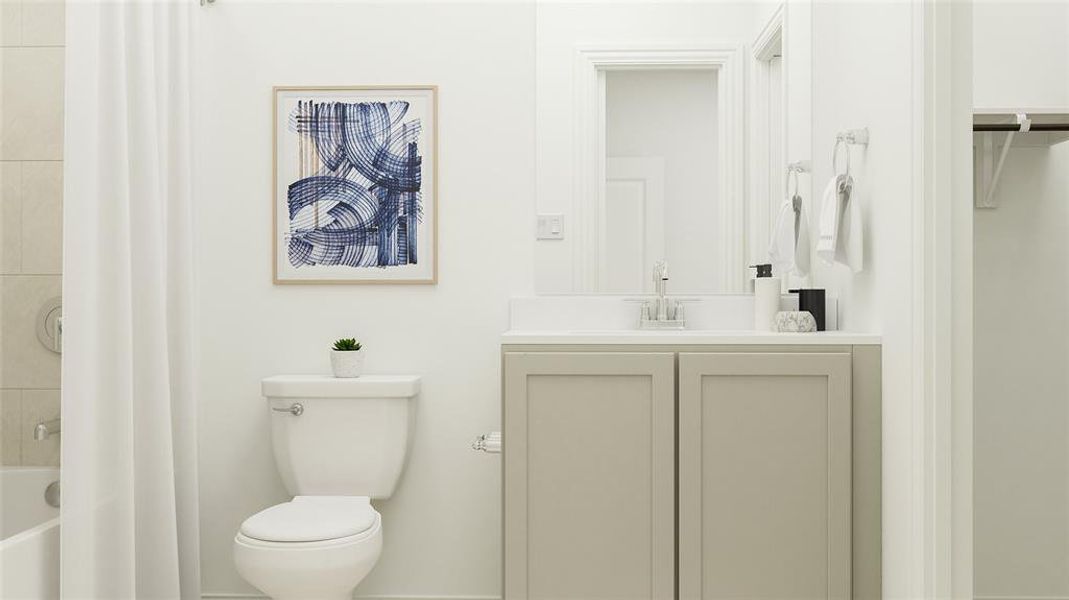 Bathroom featuring a tub, vanity, and toilet