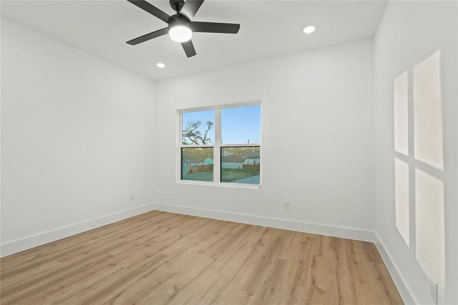 Unfurnished room with light wood finished floors, ceiling fan, and recessed lighting