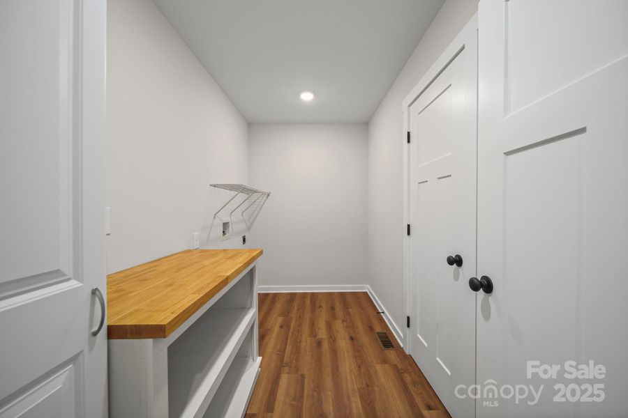 Nicely appointed laundry room with folding table and cabinet. Nicely appointed laundry room with folding table and cabinet.