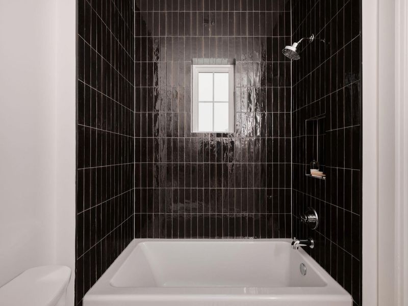 Full bath featuring washtub / shower combination and toilet Full bath featuring washtub / shower combination and toilet