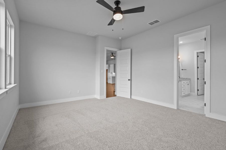 A room with a ceiling fan and a door. A room with a ceiling fan and a door.