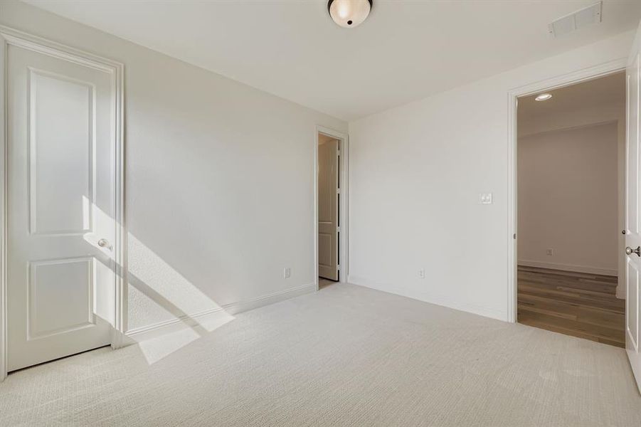 Unfurnished bedroom featuring light colored carpet and recessed lighting