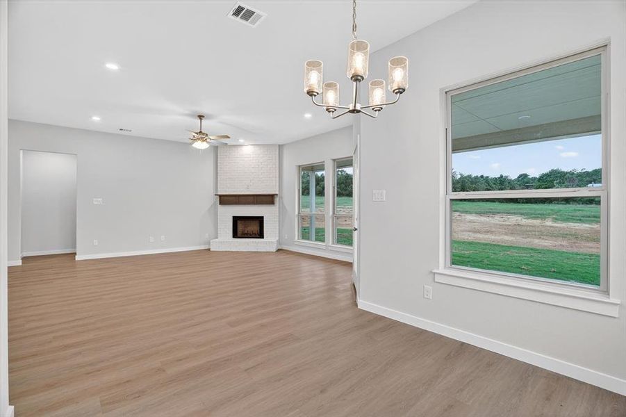 Spacious open-concept interior featuring light wood-finish flooring and recessed lighting