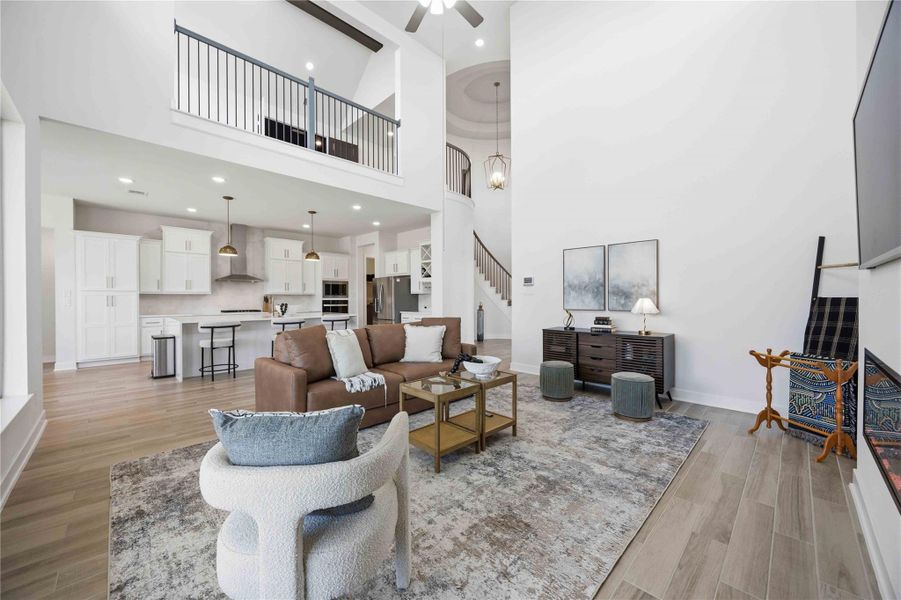 An extraordinary gathering space featuring soaring ceilings, expansive windows, and seamless connection to surrounding living areas.