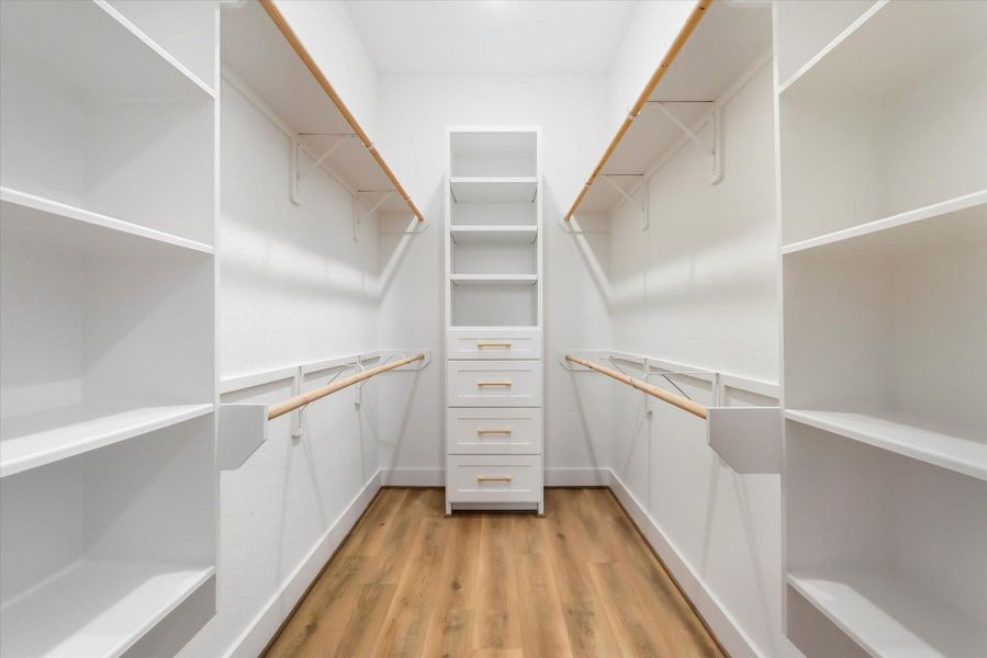 The photo speaks for itself, doesn’t it? Custom primary closet with plenty or room for hanging and storing.