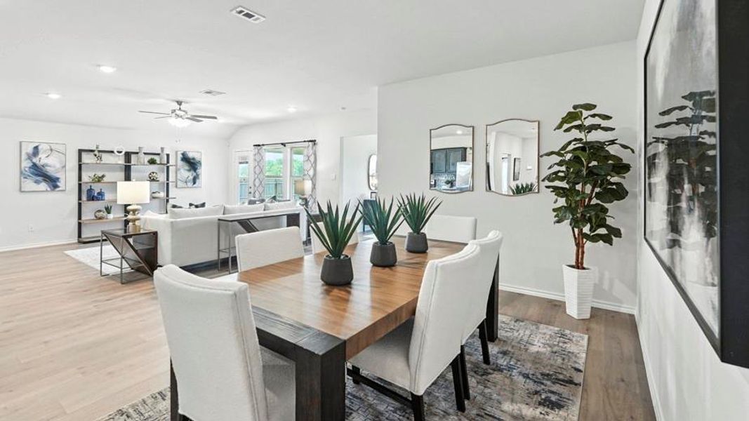 Dining space with wood finished floors, a ceiling fan, and recessed lighting Dining space with wood finished floors, a ceiling fan, and recessed lighting
